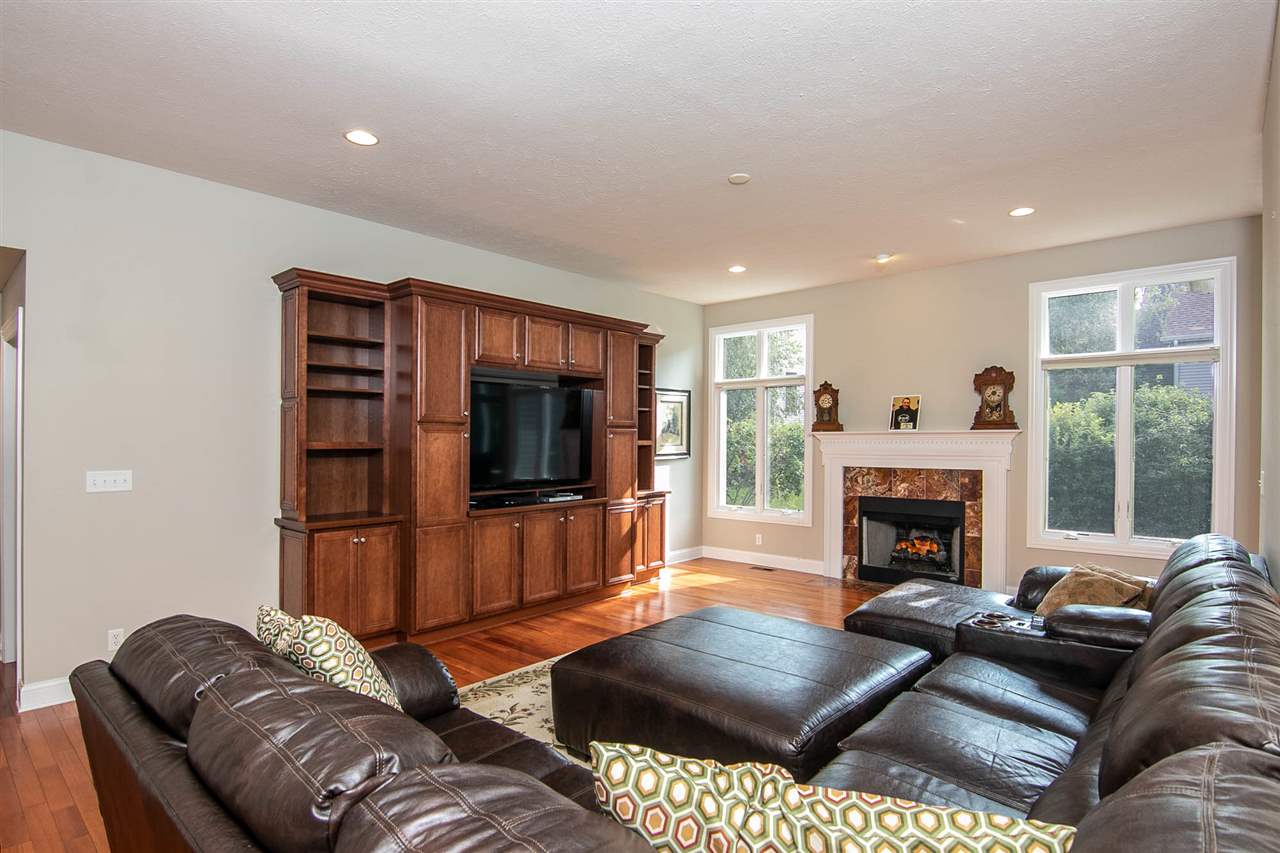 637 Roxbury Road Rockford, IL 61107 - Photo 12 of 25 a living room with furniture a flat screen tv and a fireplace