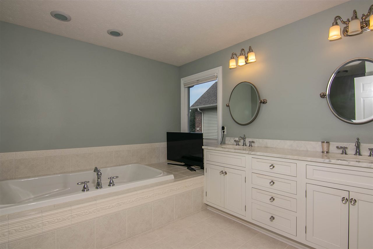 637 Roxbury Road Rockford, IL 61107 - Photo 13 of 25 a bathroom with a double vanity sink and a mirror