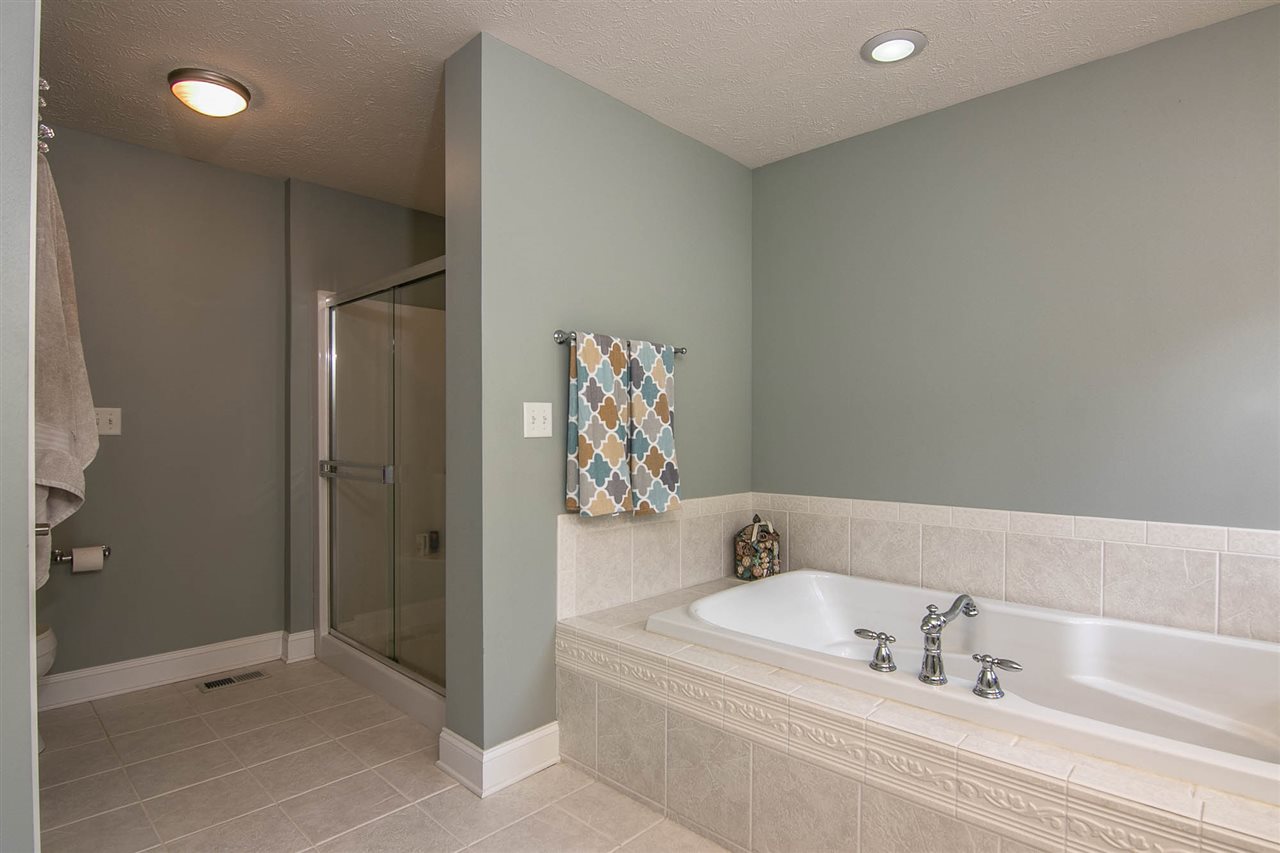 637 Roxbury Road Rockford, IL 61107 - Photo 14 of 25 a bathroom with a bathtub and a shower