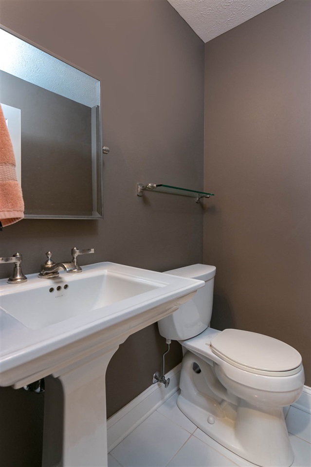 637 Roxbury Road Rockford, IL 61107 - Photo 21 of 25 a bathroom with a sink a toilet and mirror