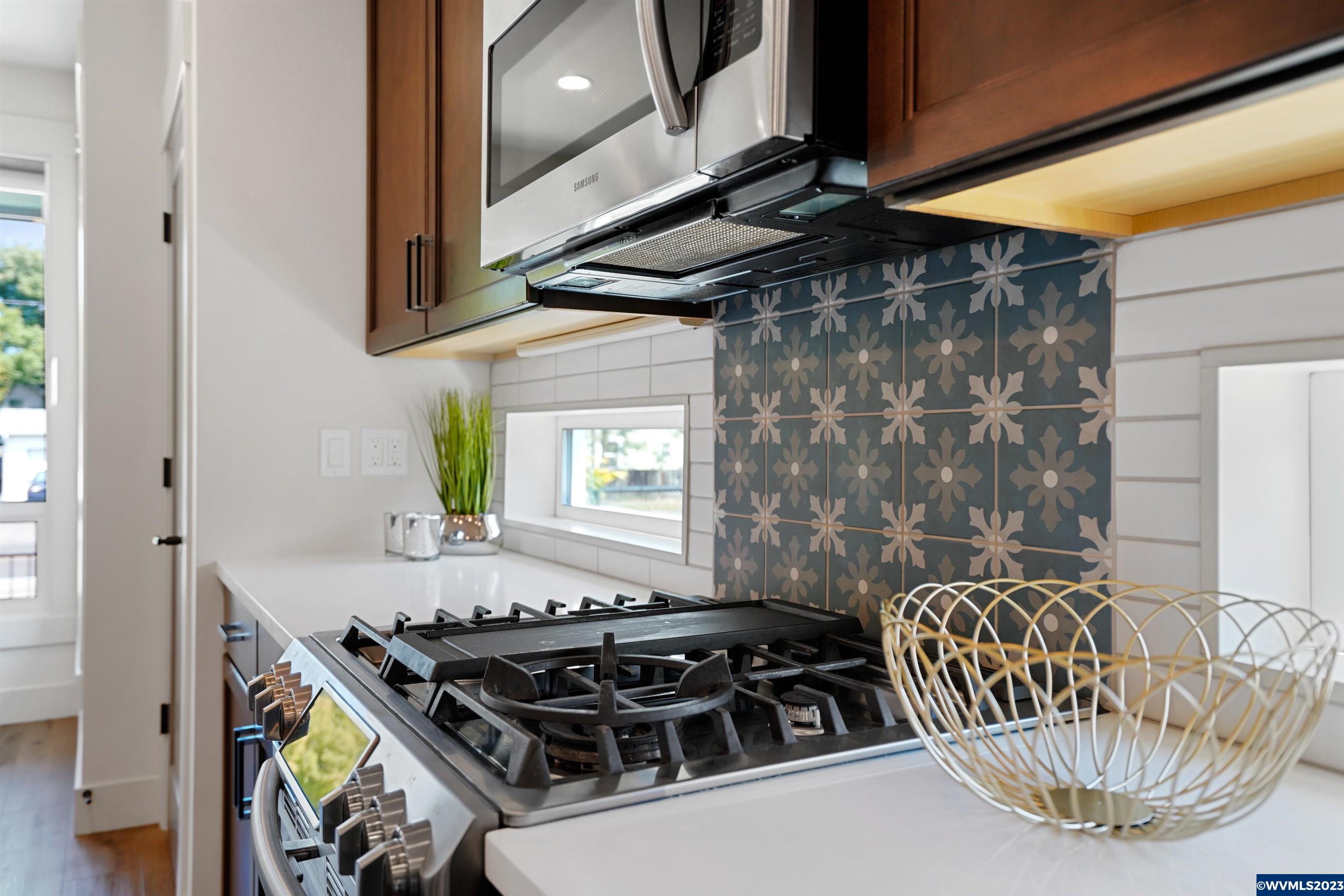 1956 Southwest 53rd Street Corvallis, OR 97333 - Photo 8 of 41 a kitchen with stainless steel appliances granite countertop a sink a stove and a microwave