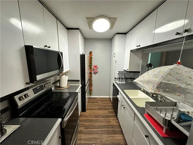 a kitchen with stainless steel appliances a stove and a microwave
