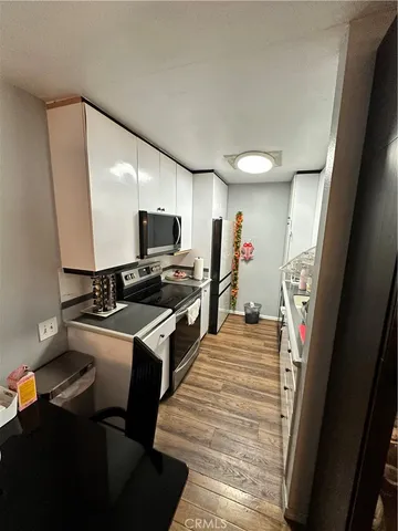 a kitchen with stainless steel appliances a stove refrigerator and a sink
