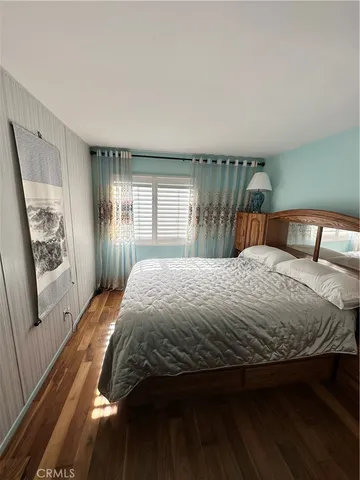 a bedroom with a large bed and a large window