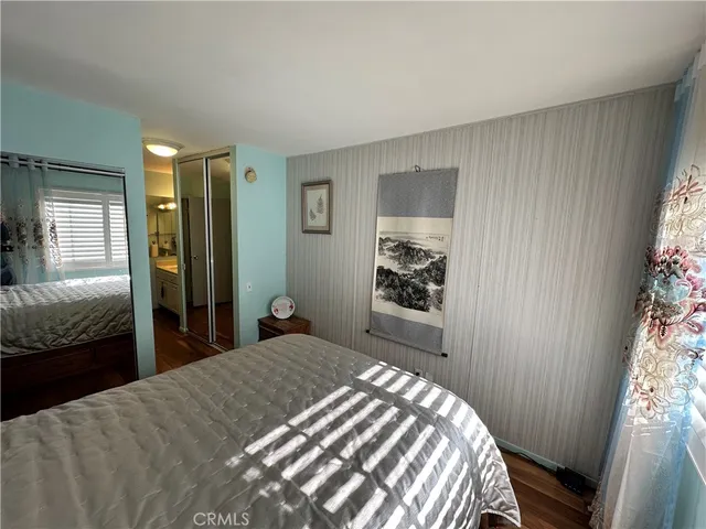 a bedroom with a bed and a mirror