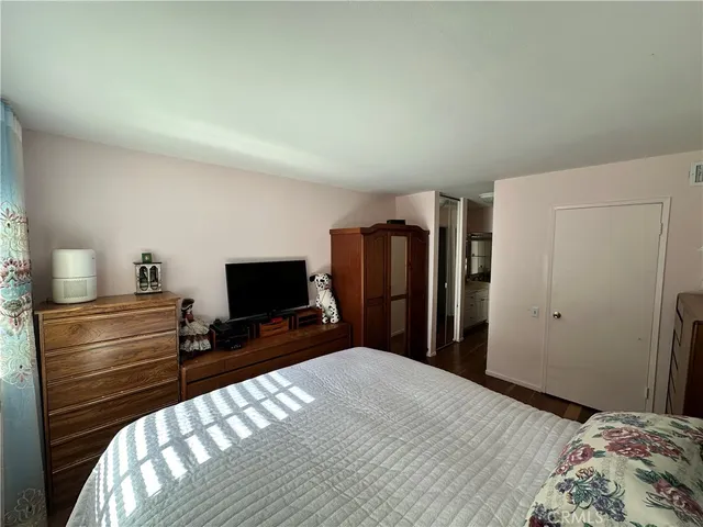 a bedroom with a bed and a flat screen tv