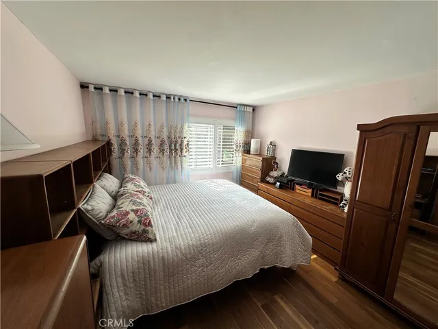 a bedroom with a bed and flat screen tv