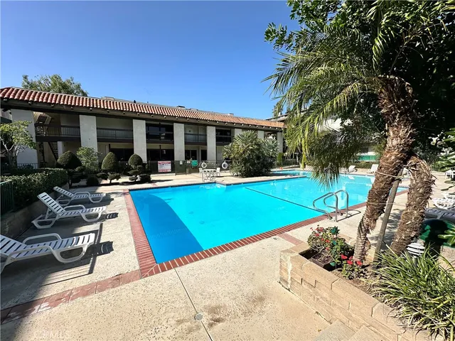 a view of a house with swimming pool and sitting area