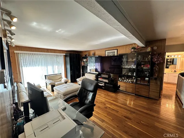 a living room with furniture a wooden floor and a window
