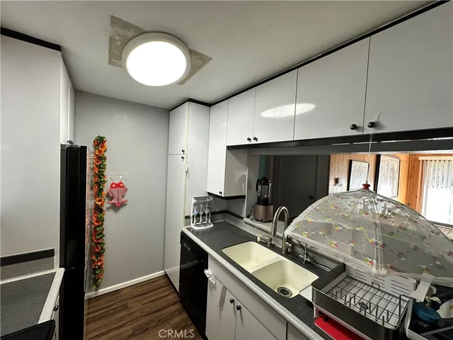 a kitchen with a refrigerator and a stove top oven