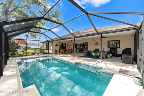 swimming pool view with a garden
