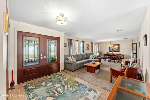 a kitchen with stainless steel appliances kitchen island granite countertop a sink stove and refrigerator
