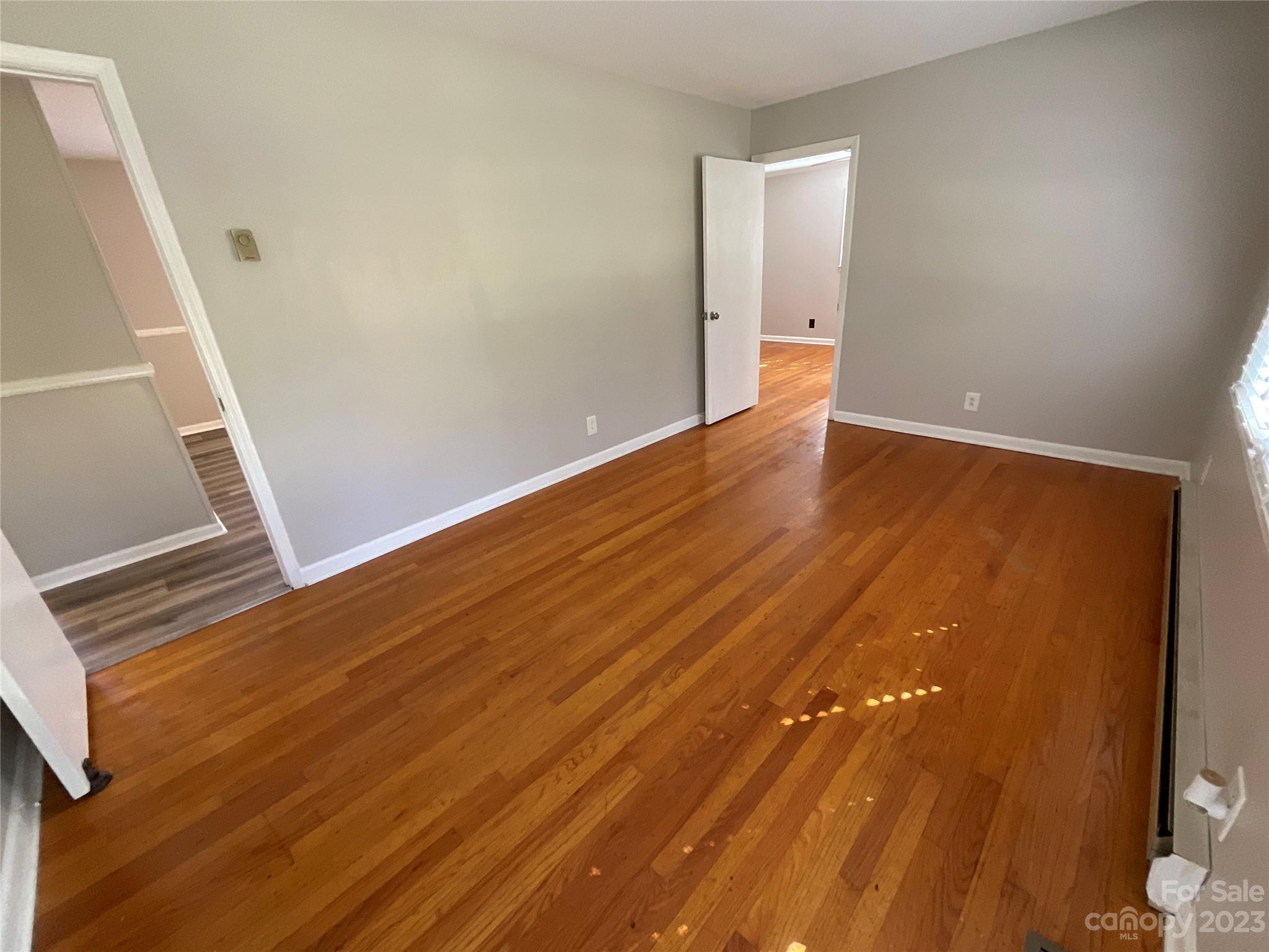 1285 Rainbow Circle Catawba, SC 29704 - Photo 12 of 22 a view of an empty room with wooden floor and a window