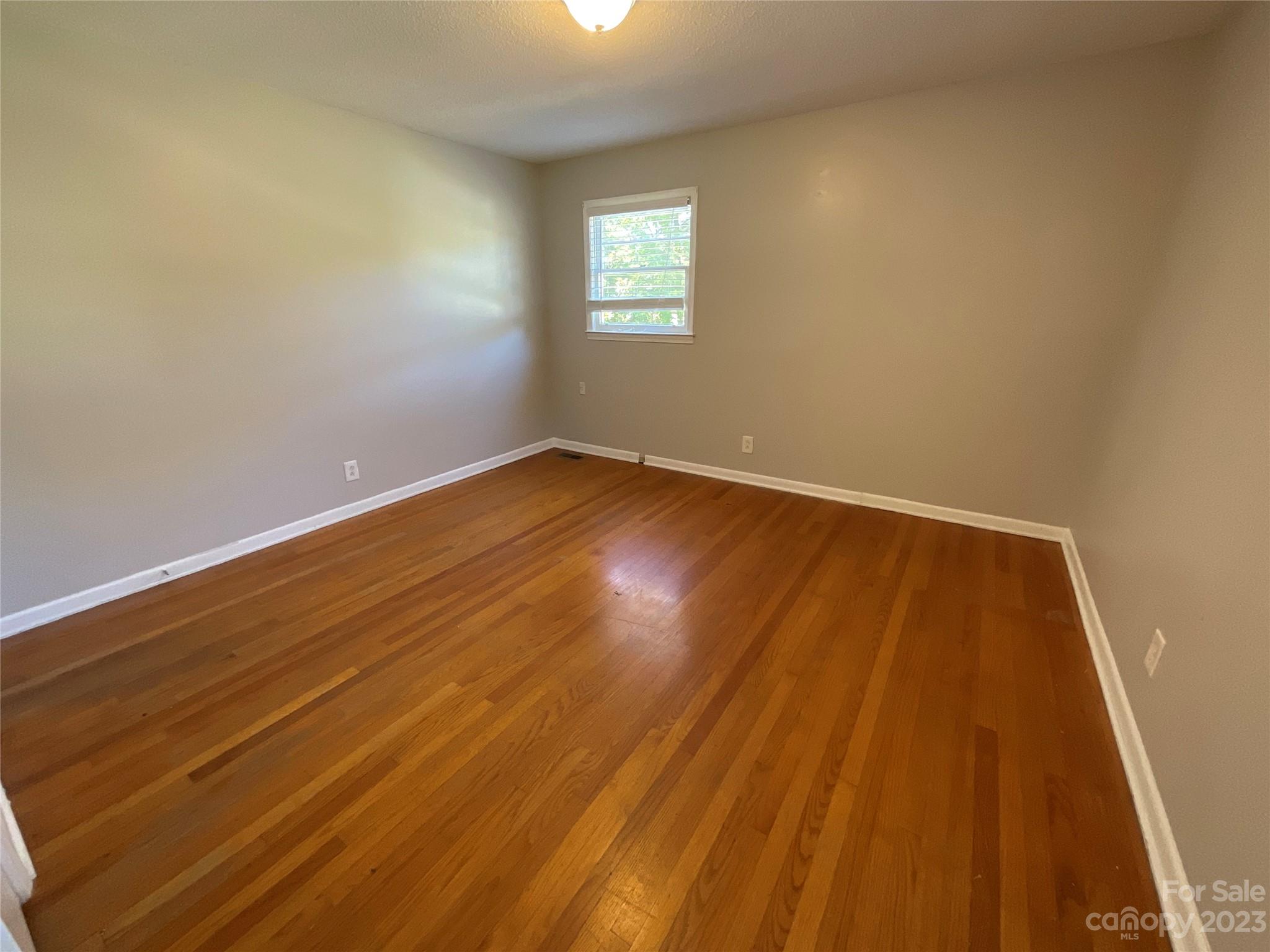 1285 Rainbow Circle Catawba, SC 29704 - Photo 14 of 22 an empty room with wooden floor and windows
