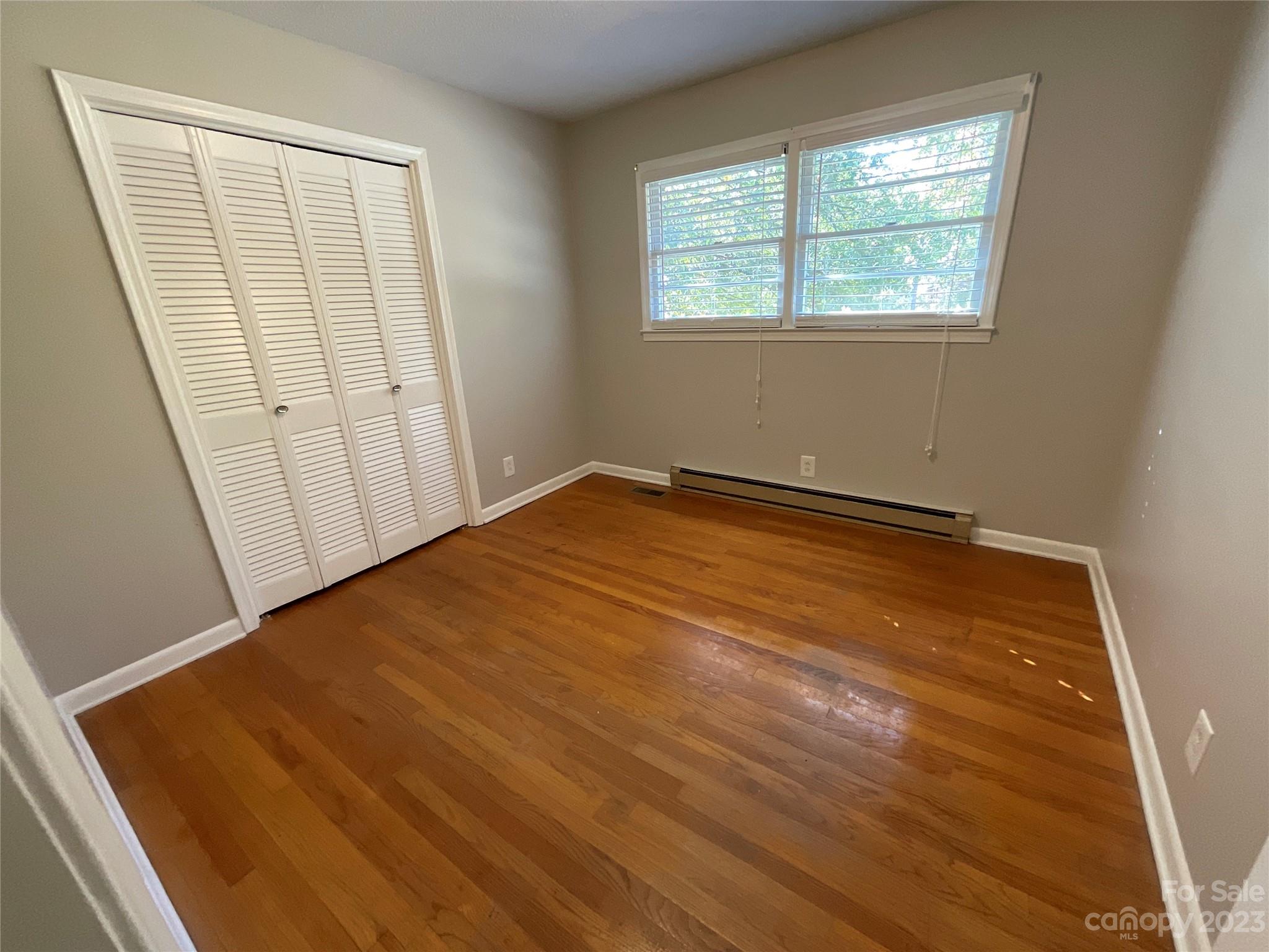 1285 Rainbow Circle Catawba, SC 29704 - Photo 16 of 22 a view of an empty room with wooden floor and a window
