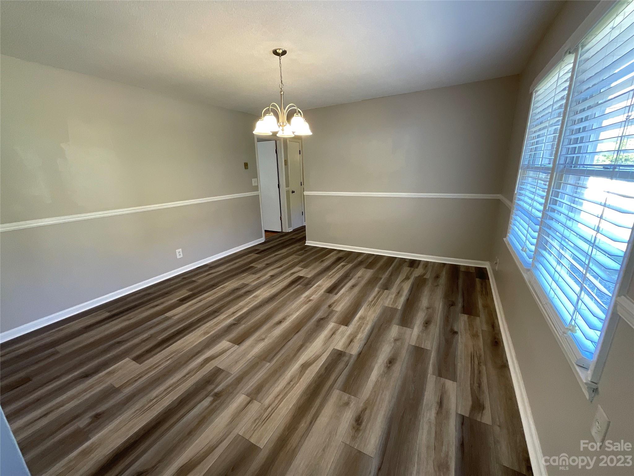1285 Rainbow Circle Catawba, SC 29704 - Photo 7 of 22 a view of a room with wooden floor staircase and a kitchen space