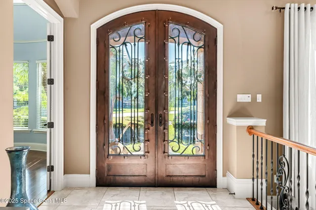a kitchen with stainless steel appliances kitchen island granite countertop a table chairs stove and kitchen island