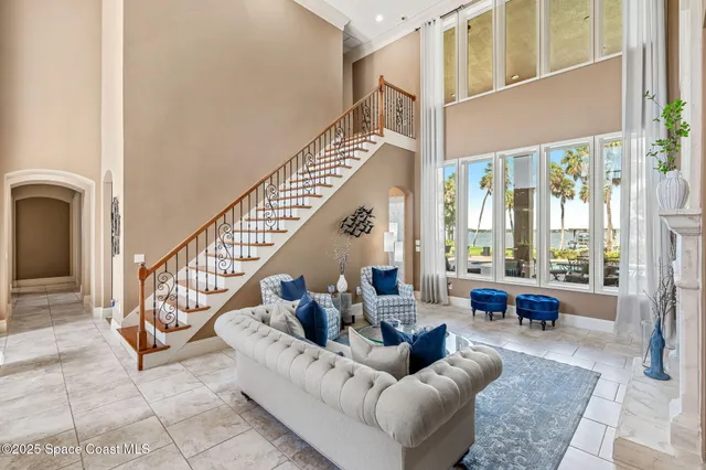 a living room with furniture a window and a chandelier