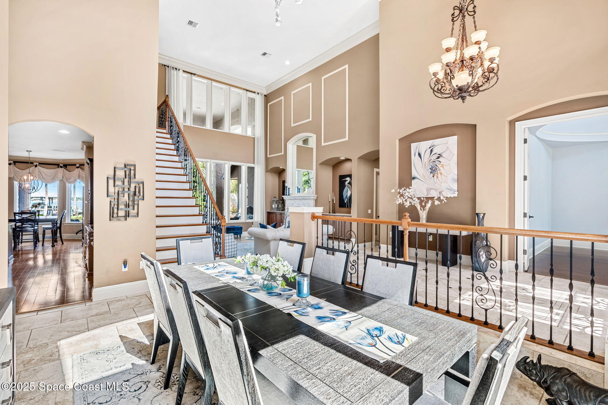 4297 Crooked Mile Road Merritt Island, FL 32952 - Photo 19 of 118 a view of a dining room with furniture a chandelier and wooden floor