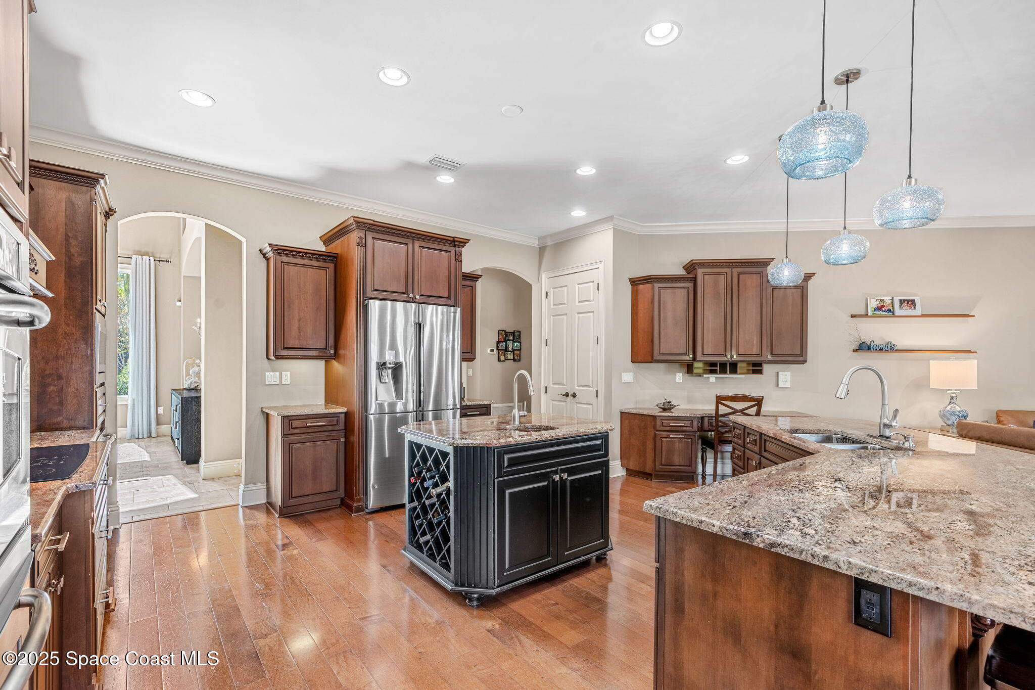 4297 Crooked Mile Road Merritt Island, FL 32952 - Photo 24 of 118 a kitchen with stainless steel appliances granite countertop a sink stove and refrigerator