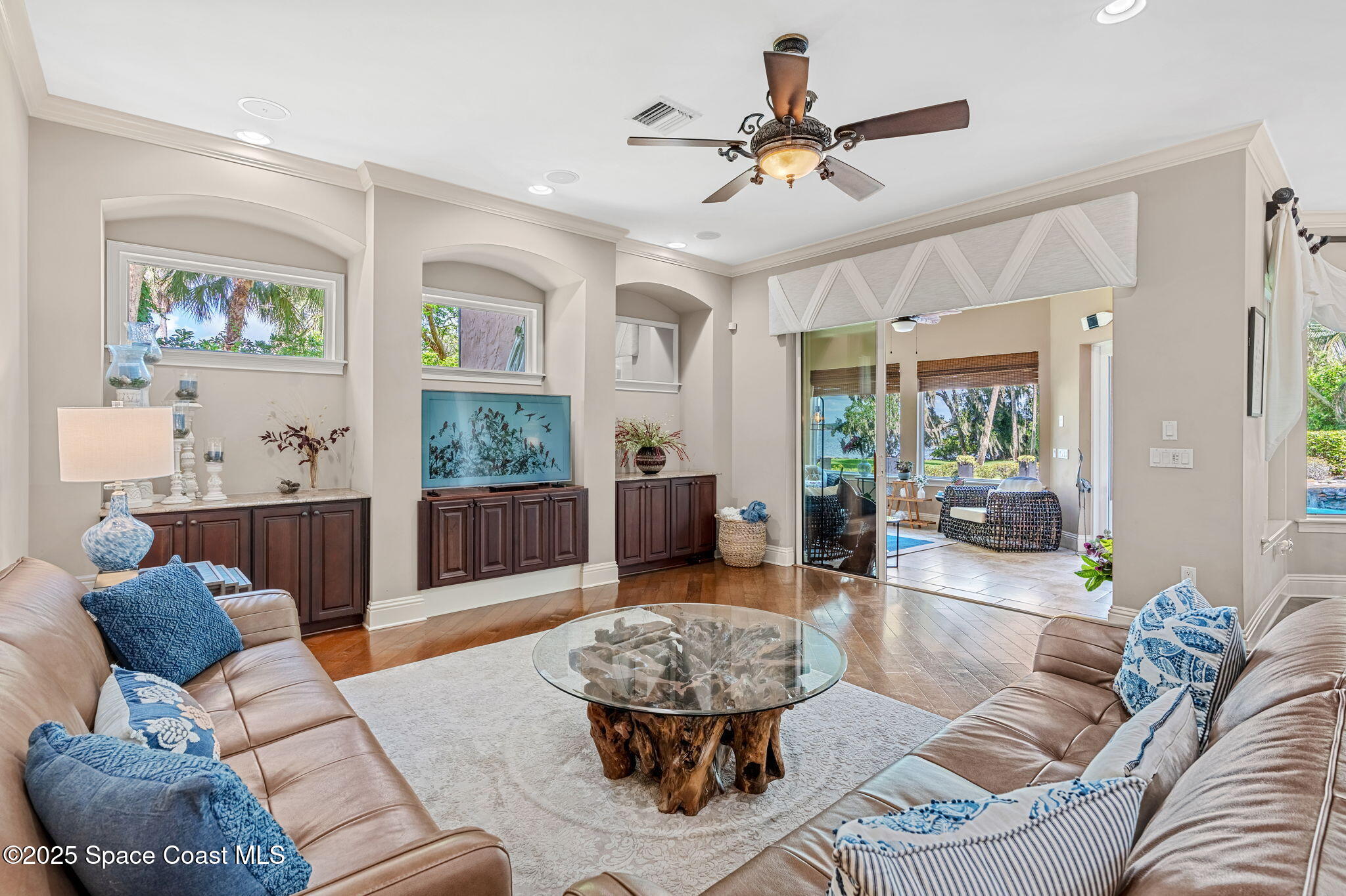 4297 Crooked Mile Road Merritt Island, FL 32952 - Photo 29 of 118 a living room with furniture a window and a chandelier
