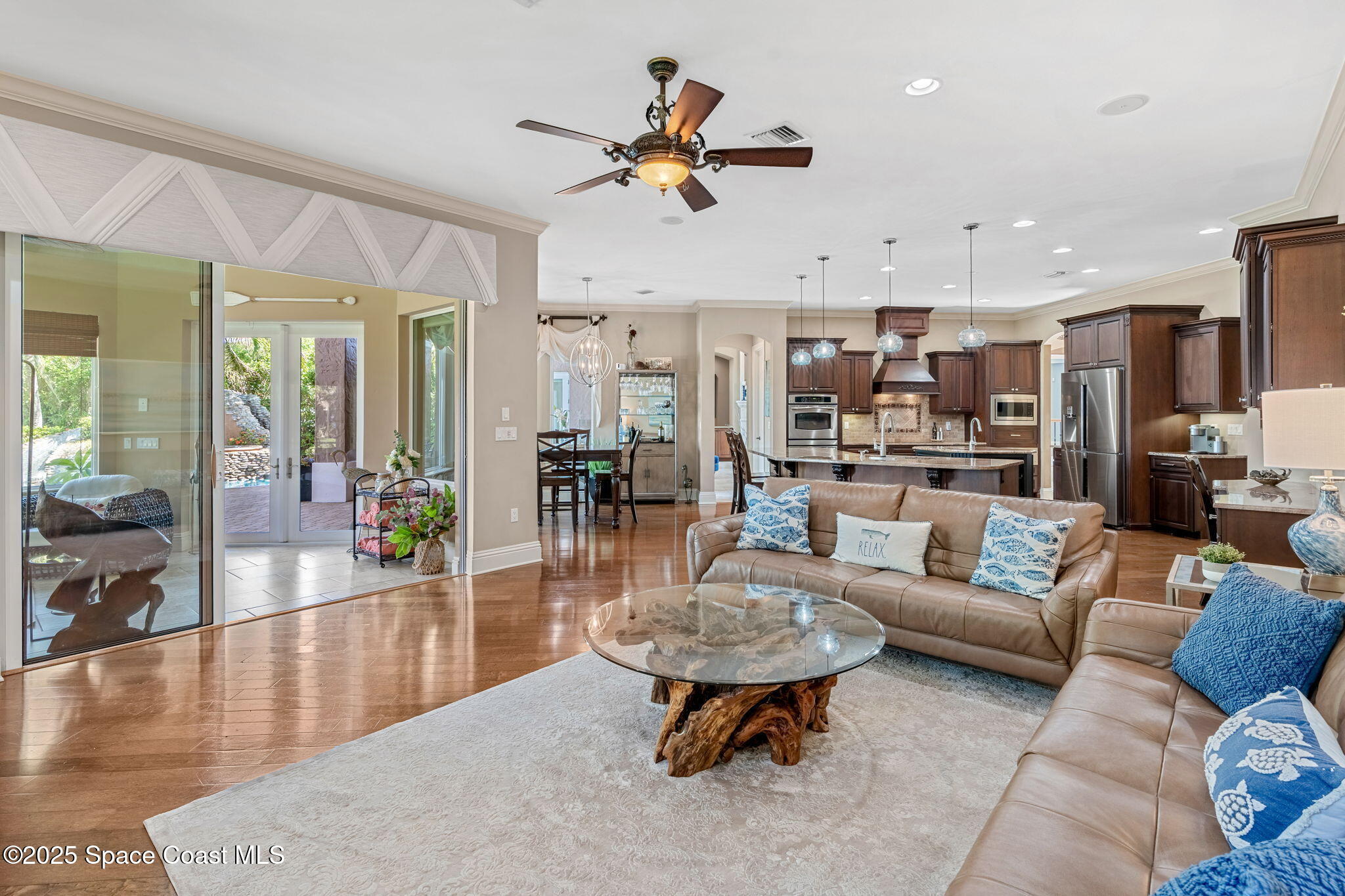 4297 Crooked Mile Road Merritt Island, FL 32952 - Photo 30 of 118 a living room with furniture kitchen view and a large window