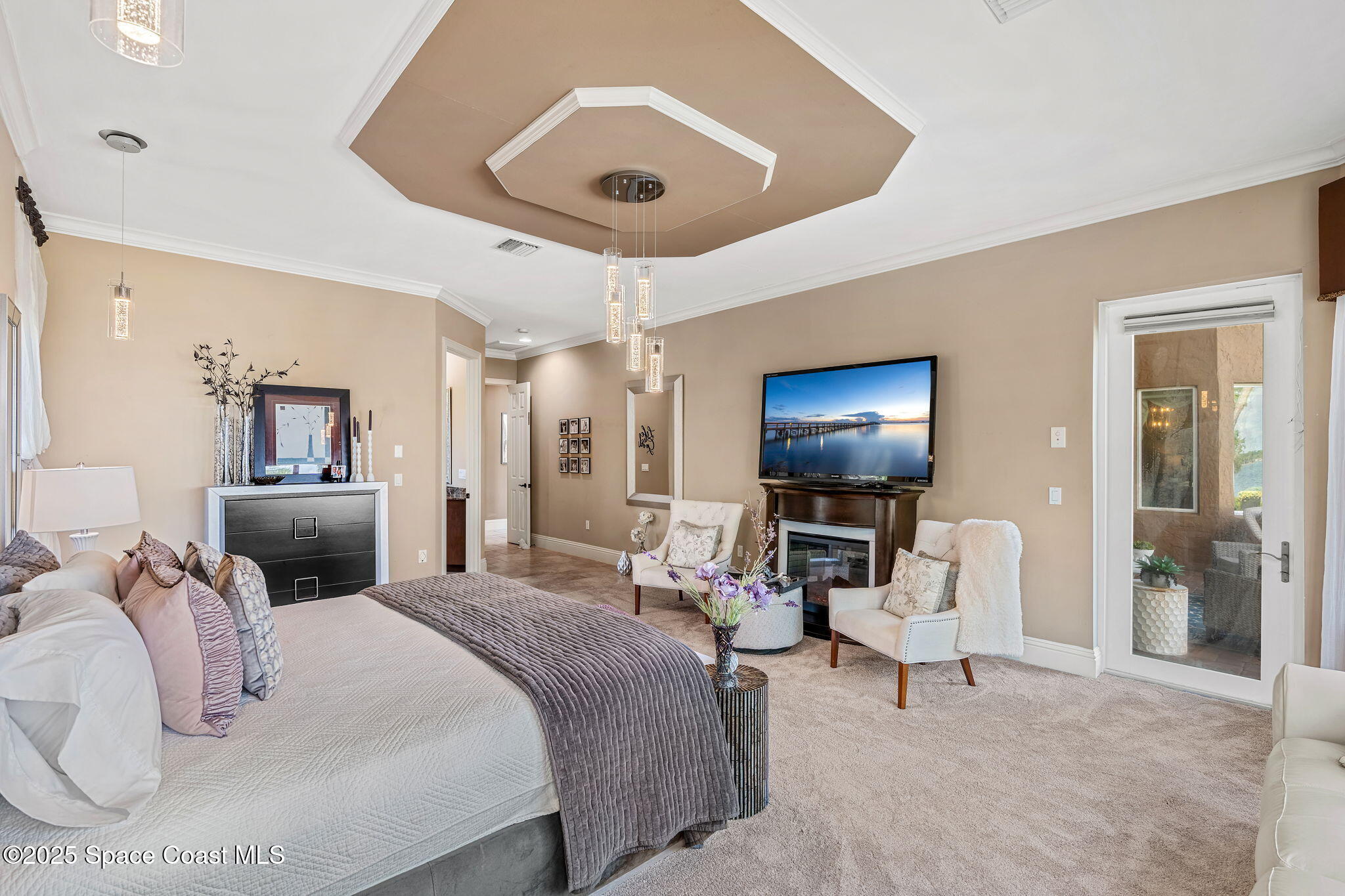 4297 Crooked Mile Road Merritt Island, FL 32952 - Photo 36 of 118 a bedroom with a bed and a chandelier