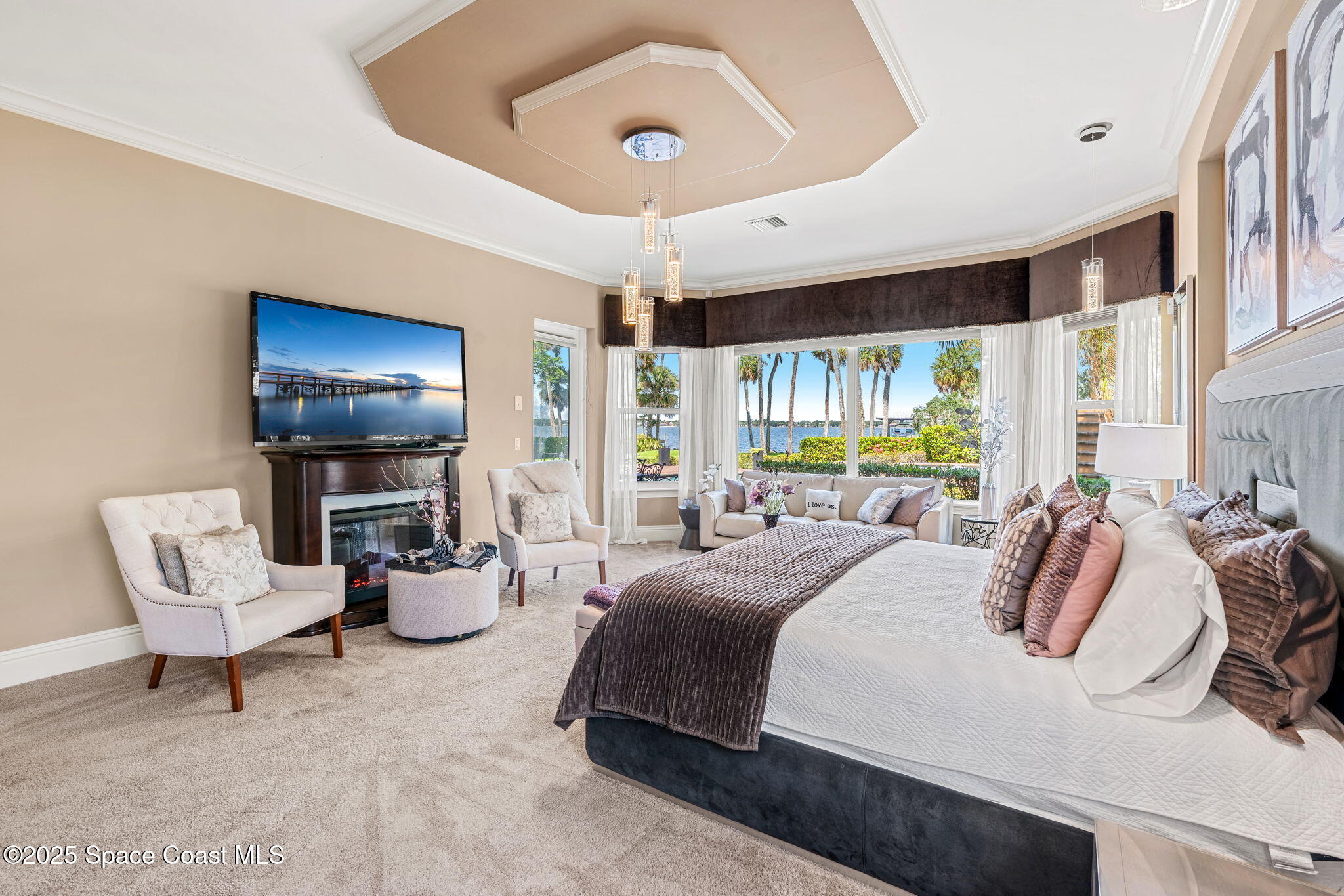 4297 Crooked Mile Road Merritt Island, FL 32952 - Photo 37 of 118 a bedroom with a bed a couch and a large window