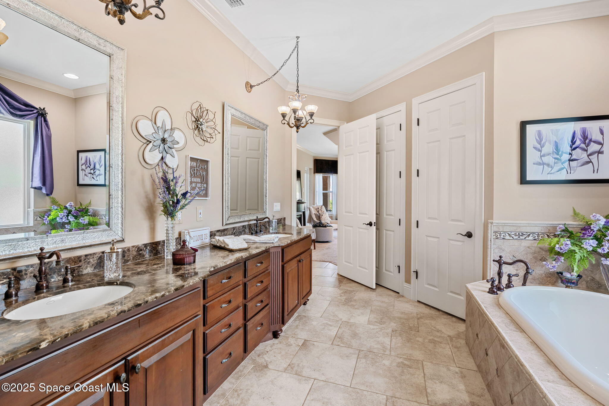 4297 Crooked Mile Road Merritt Island, FL 32952 - Photo 40 of 118 a spacious bathroom with a granite countertop tub a double vanity sink a vanity and a large mirror