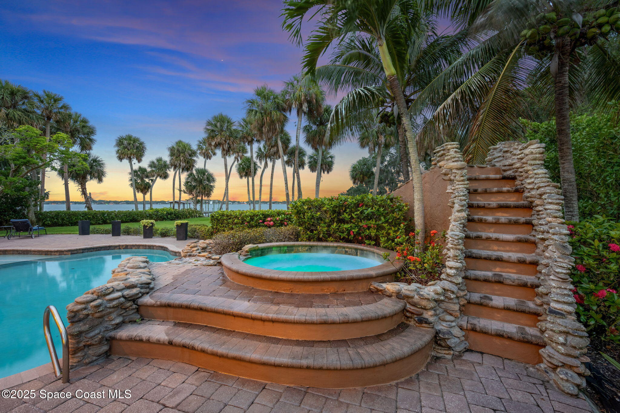 4297 Crooked Mile Road Merritt Island, FL 32952 - Photo 4 of 118 a view of a backyard with plants and lake