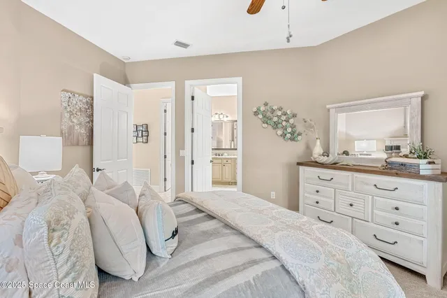 a front view of a house with a yard and potted plants