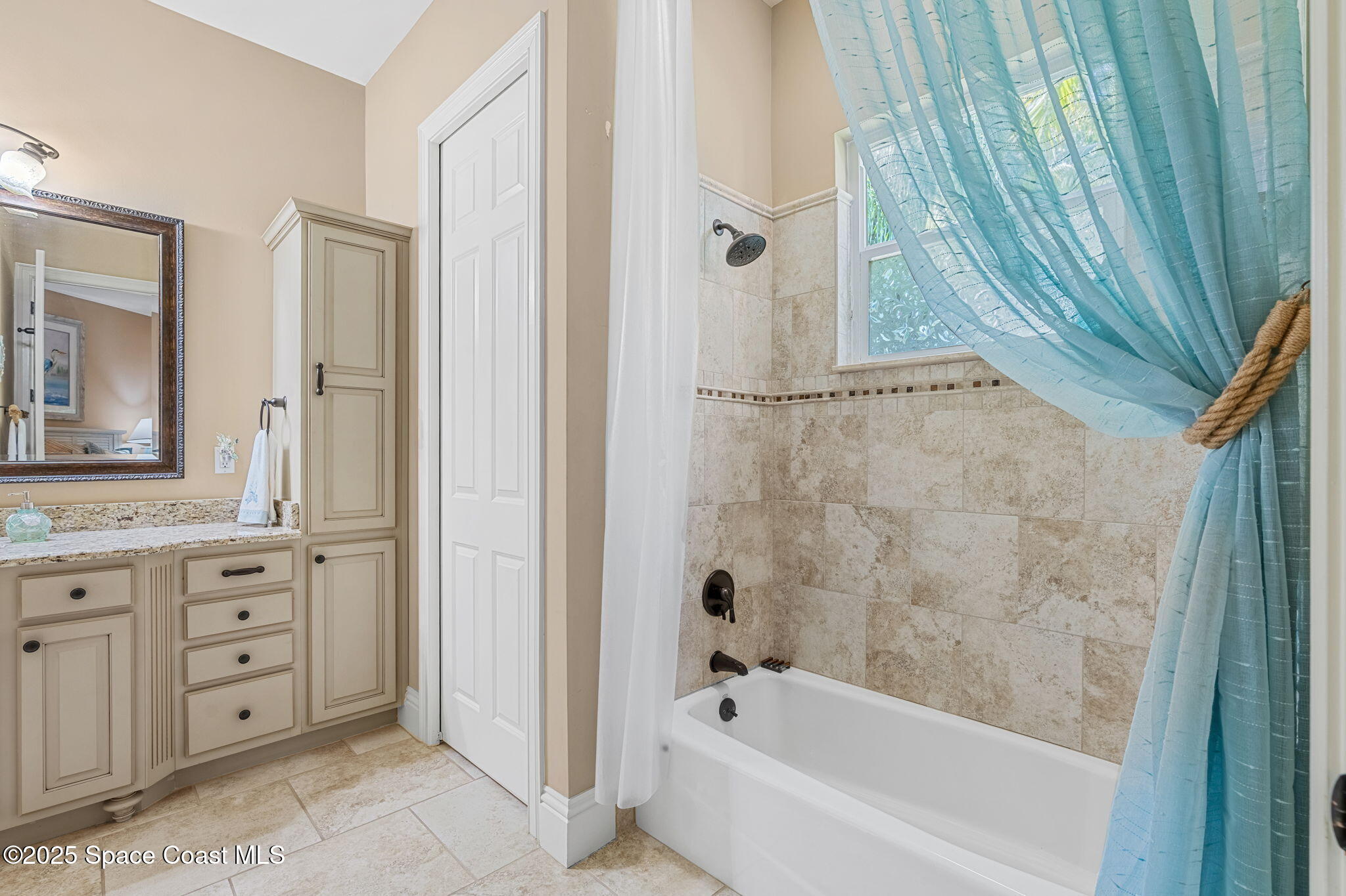 4297 Crooked Mile Road Merritt Island, FL 32952 - Photo 45 of 118 a bathroom with a bathtub a sink a vanity and a shower