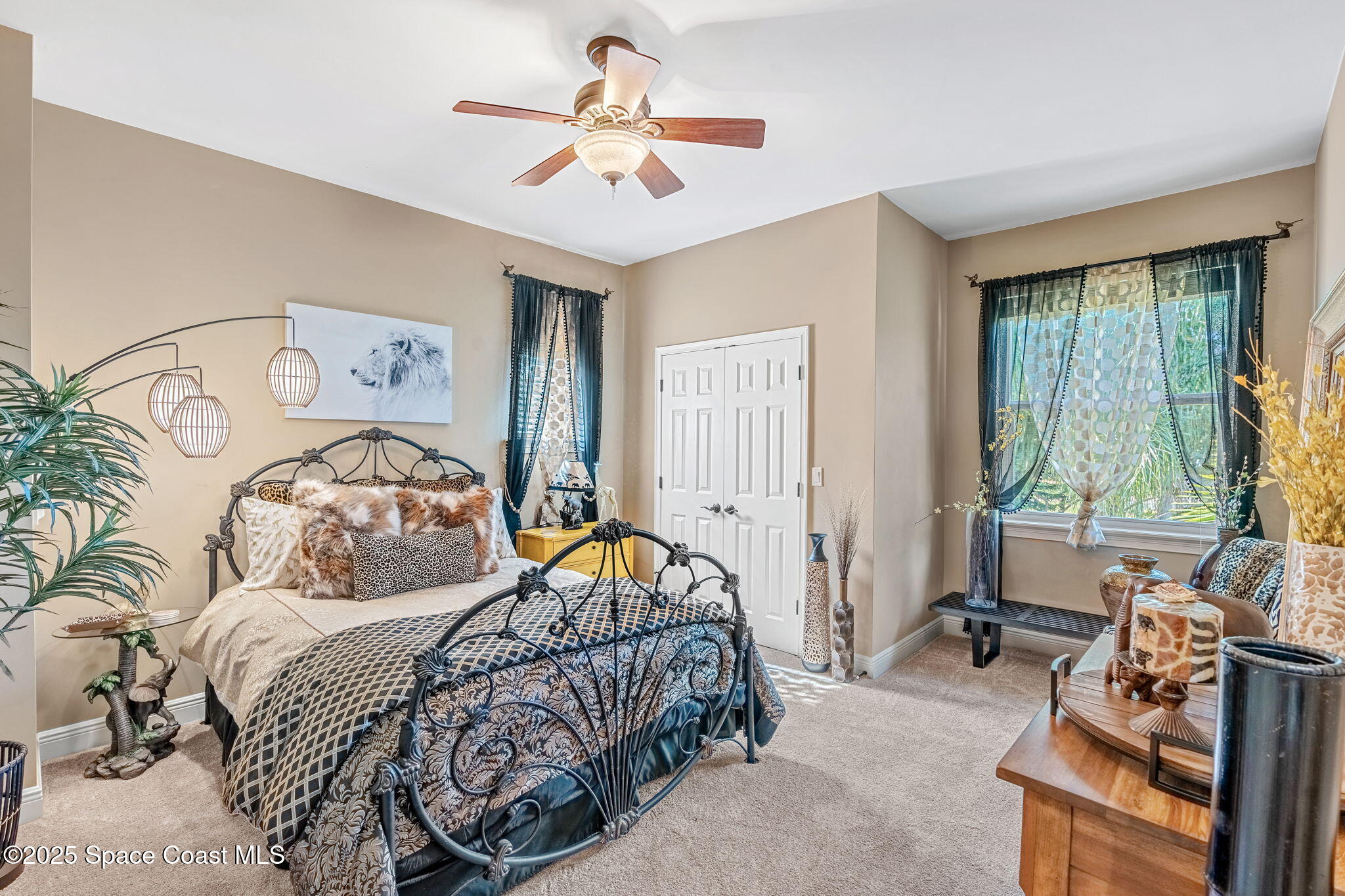 4297 Crooked Mile Road Merritt Island, FL 32952 - Photo 59 of 118 a bedroom with a bed and a chandelier