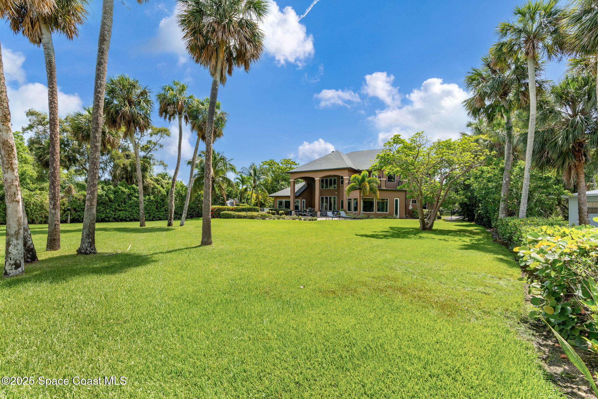 4297 Crooked Mile Road Merritt Island, FL 32952 - Photo 81 of 118 a view of house with swimming pool and trees in the background