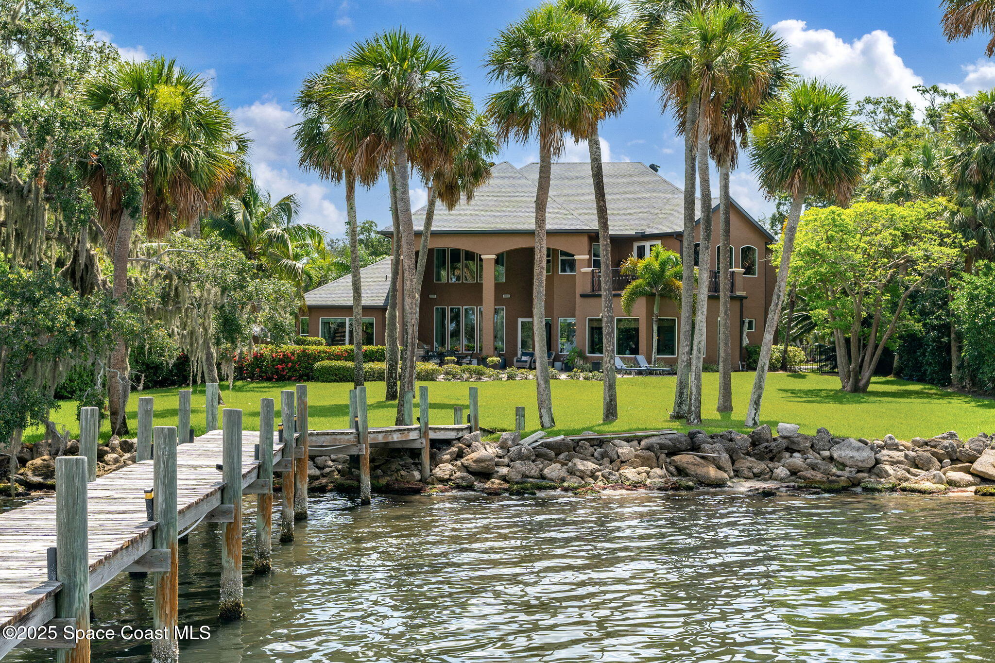4297 Crooked Mile Road Merritt Island, FL 32952 - Photo 83 of 118 a view of a swimming pool with a patio and a garden