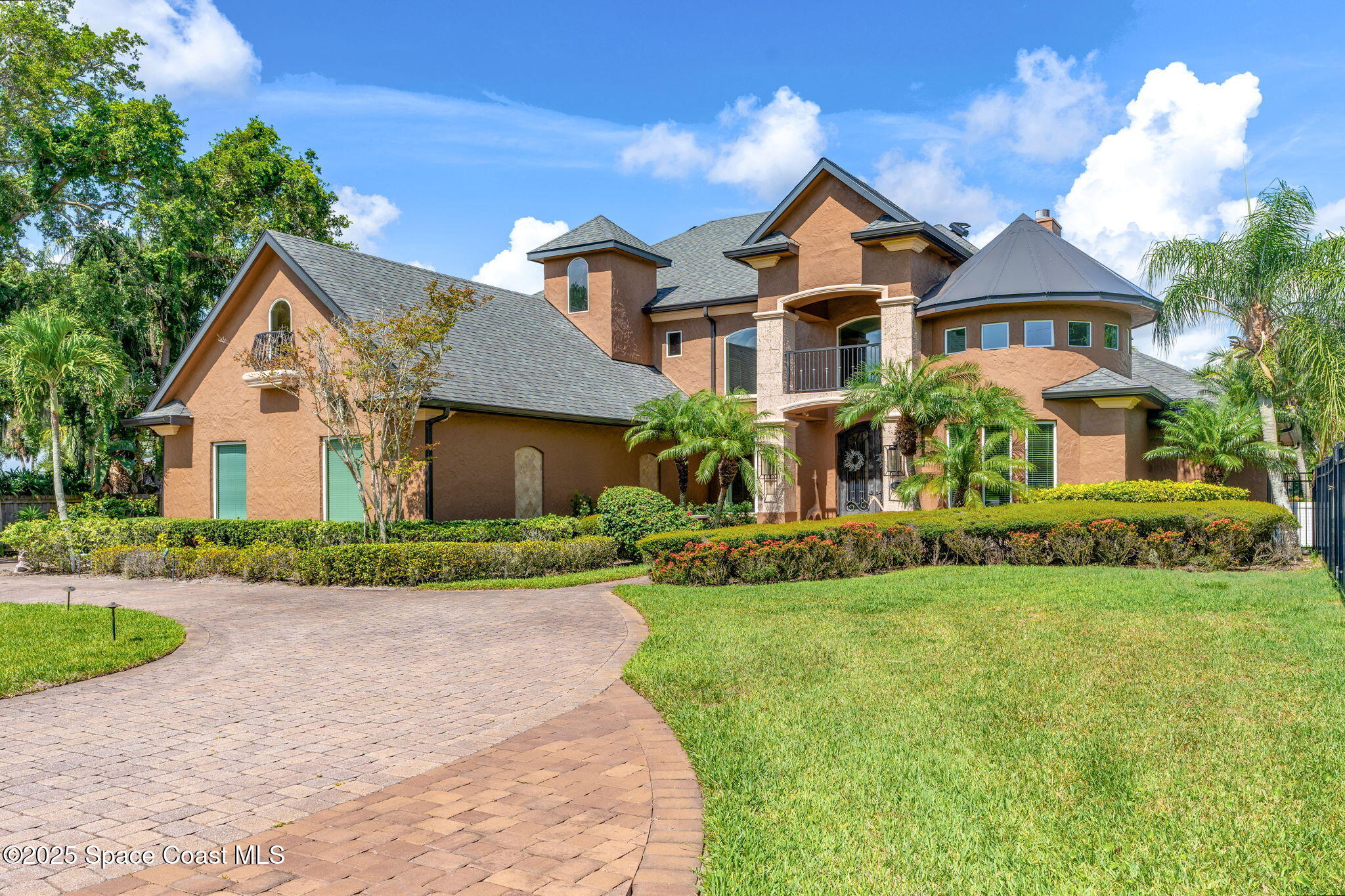 4297 Crooked Mile Road Merritt Island, FL 32952 - Photo 9 of 118 a front view of a house with a garden and plants
