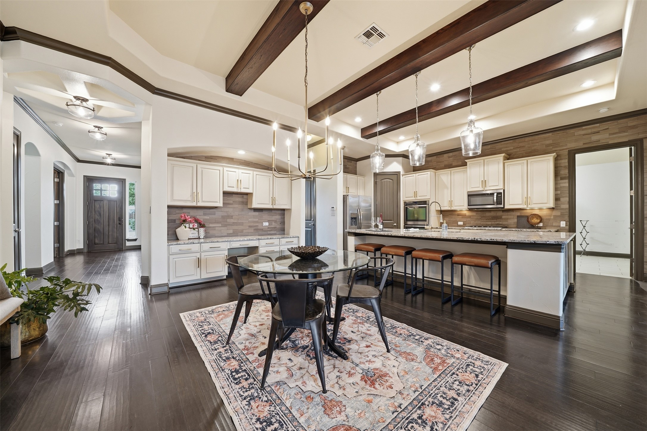 8729 Vantage Point Drive Austin, TX 78737 - Photo 14 of 33 Bold wood ceiling beams define this open-concept kitchen with a spacious dining area.
