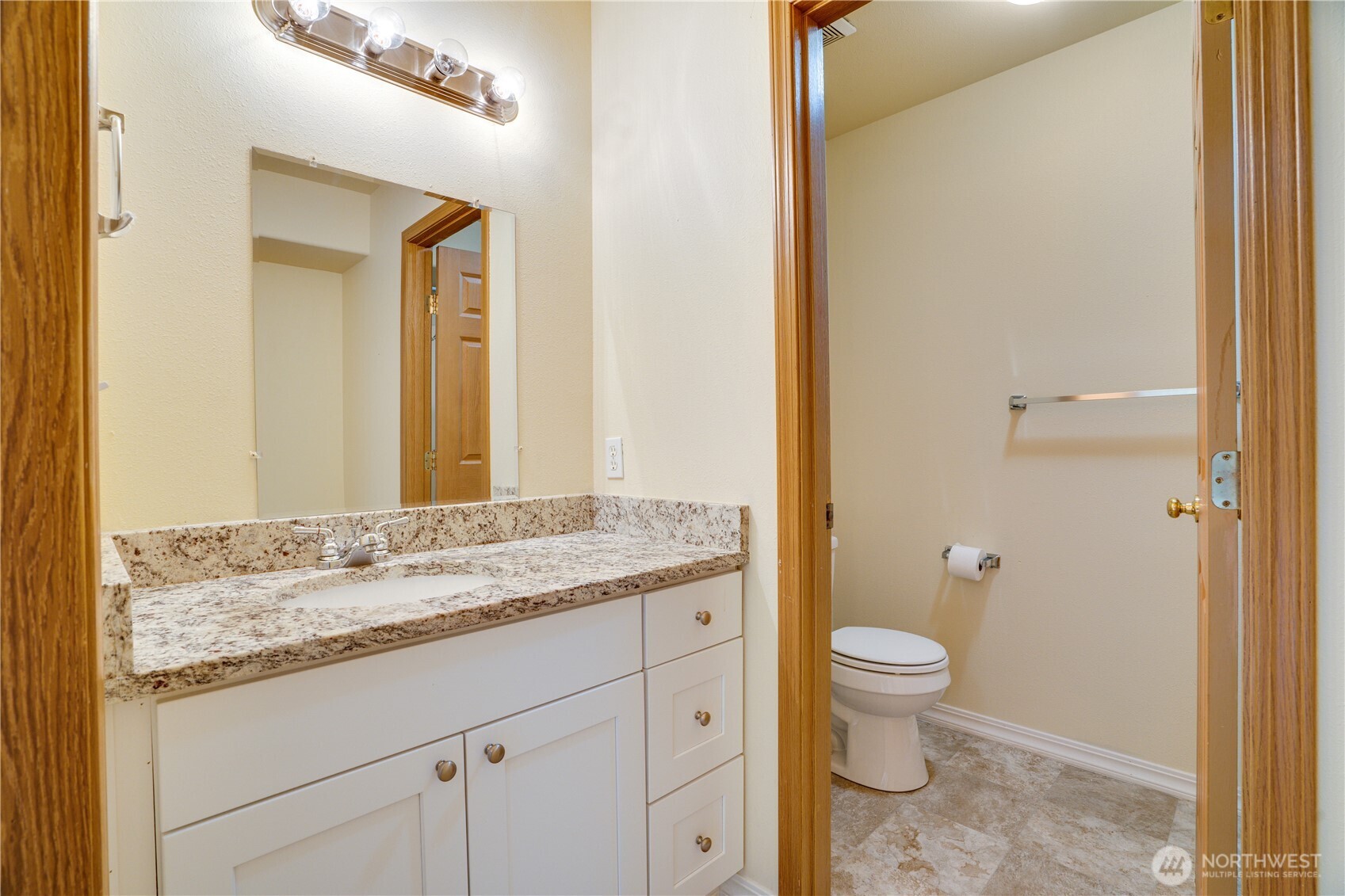 935 Southwest 319th Place Federal Way, WA 98023 - Photo 13 of 26 a bathroom with a granite countertop sink a toilet and a mirror