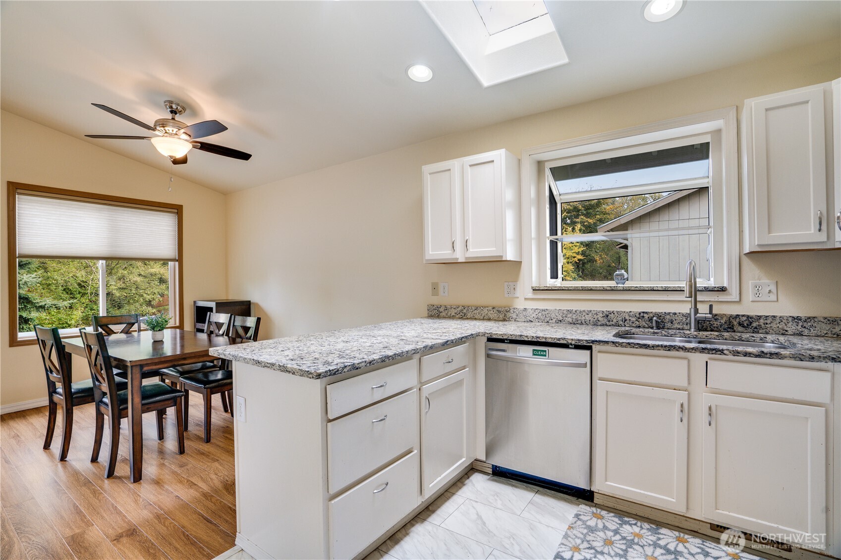 935 Southwest 319th Place Federal Way, WA 98023 - Photo 8 of 26 a kitchen with granite countertop white cabinets and white appliances