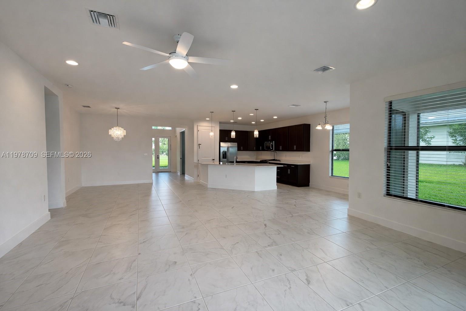10922 Southwest Meandering Mile Road, Unit 10922 Port St. Lucie, FL 34987 - Photo 18 of 56 a view of a kitchen with a sink and a stove top oven