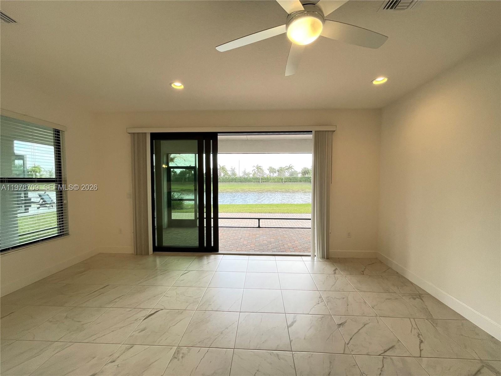 10922 Southwest Meandering Mile Road, Unit 10922 Port St. Lucie, FL 34987 - Photo 19 of 56 a view of an empty room with a window