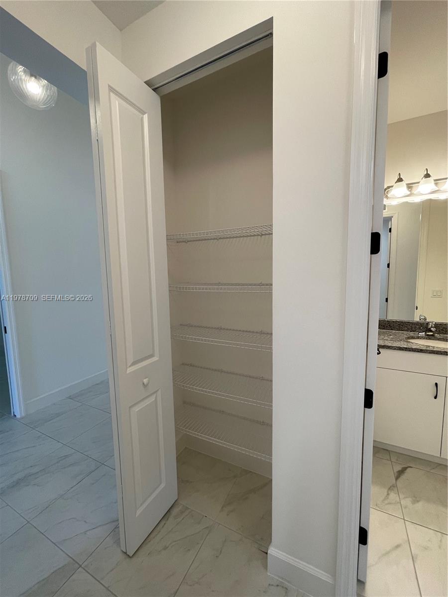 10922 Southwest Meandering Mile Road, Unit 10922 Port St. Lucie, FL 34987 - Photo 25 of 56 a bathroom with a shower and a sink