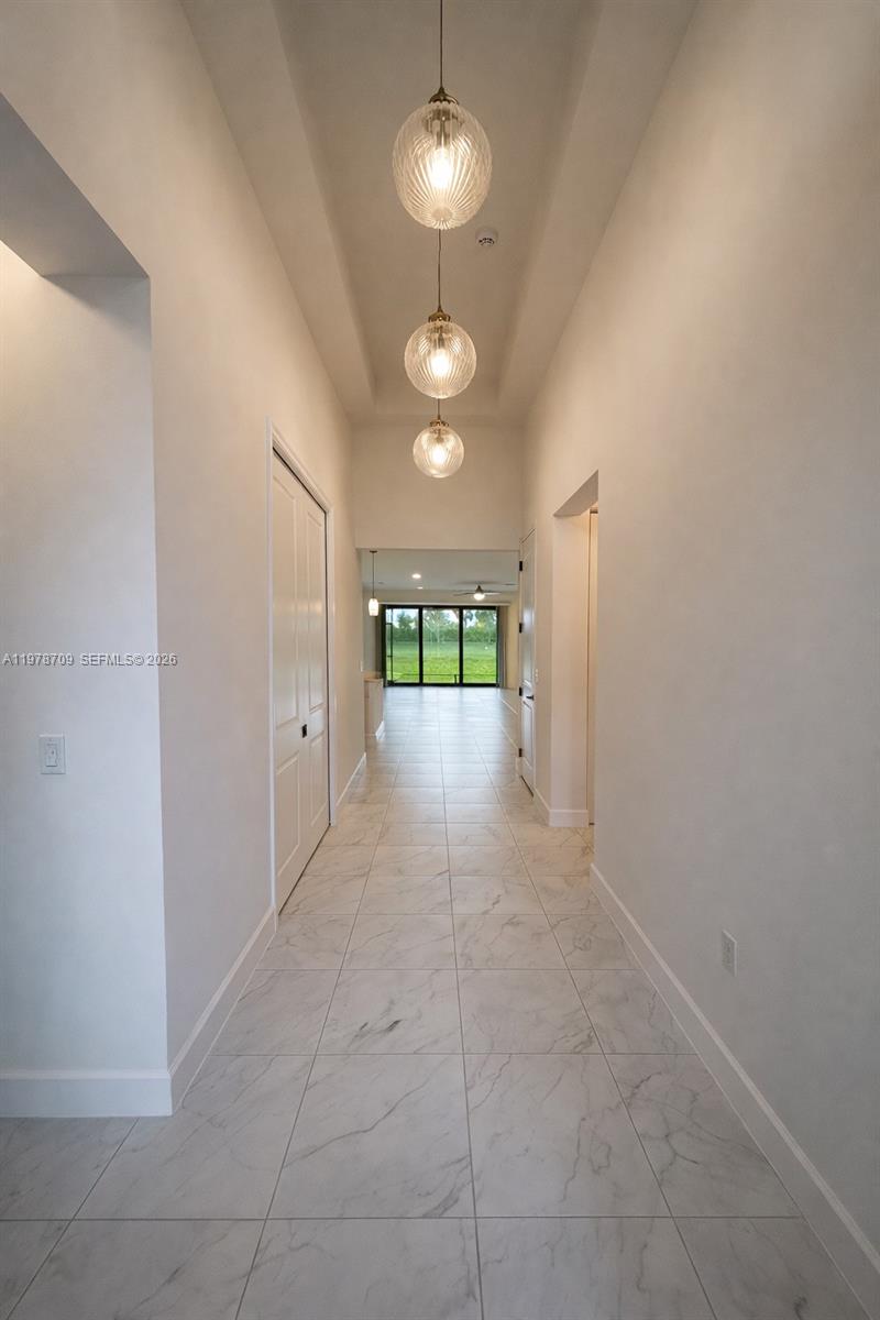 10922 Southwest Meandering Mile Road, Unit 10922 Port St. Lucie, FL 34987 - Photo 3 of 56 a view of a room window and wooden floor