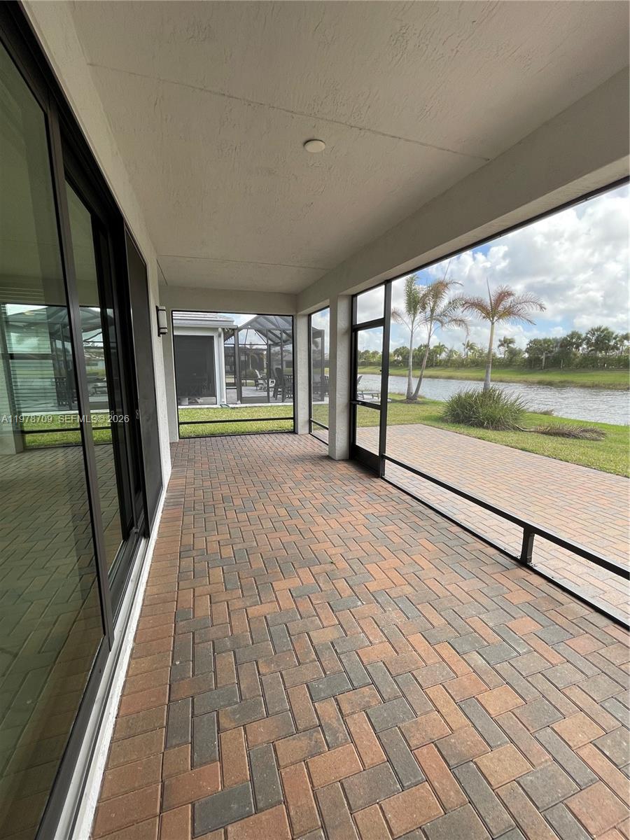 10922 Southwest Meandering Mile Road, Unit 10922 Port St. Lucie, FL 34987 - Photo 39 of 56 an empty room with wooden floor and windows
