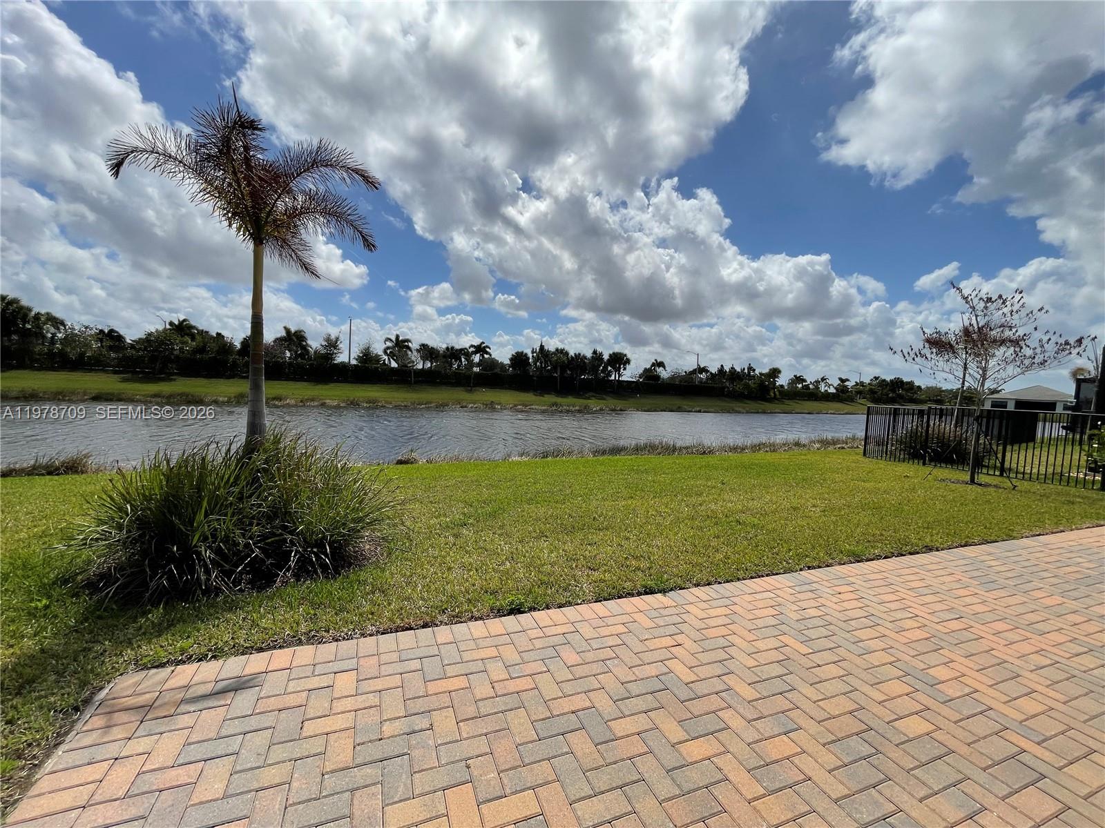 10922 Southwest Meandering Mile Road, Unit 10922 Port St. Lucie, FL 34987 - Photo 42 of 56 a view of a lake with a big yard