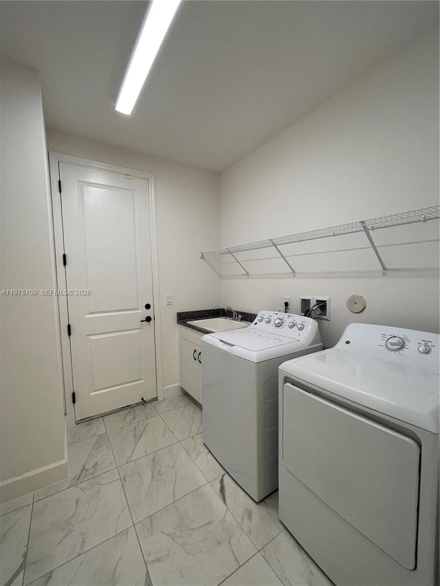 10922 Southwest Meandering Mile Road, Unit 10922 Port St. Lucie, FL 34987 - Photo 43 of 56 a view of storage and utility room with washer and dryer