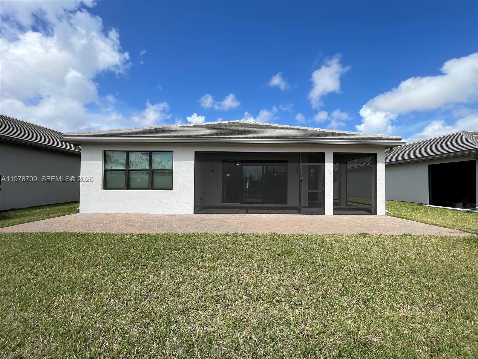 10922 Southwest Meandering Mile Road, Unit 10922 Port St. Lucie, FL 34987 - Photo 45 of 56 a house view with a garden space