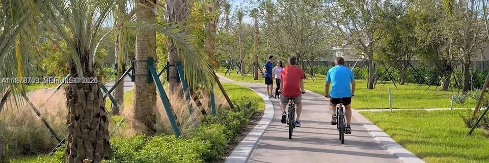 10922 Southwest Meandering Mile Road, Unit 10922 Port St. Lucie, FL 34987 - Photo 50 of 56 a view of a park with large trees