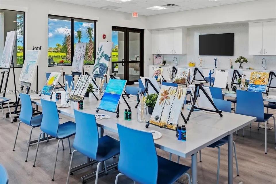 10922 Southwest Meandering Mile Road, Unit 10922 Port St. Lucie, FL 34987 - Photo 53 of 56 a view of a dining room with furniture and a flat screen tv