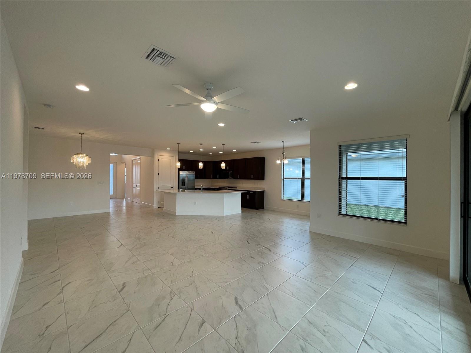 10922 Southwest Meandering Mile Road, Unit 10922 Port St. Lucie, FL 34987 - Photo 7 of 56 a view of an empty room with a window